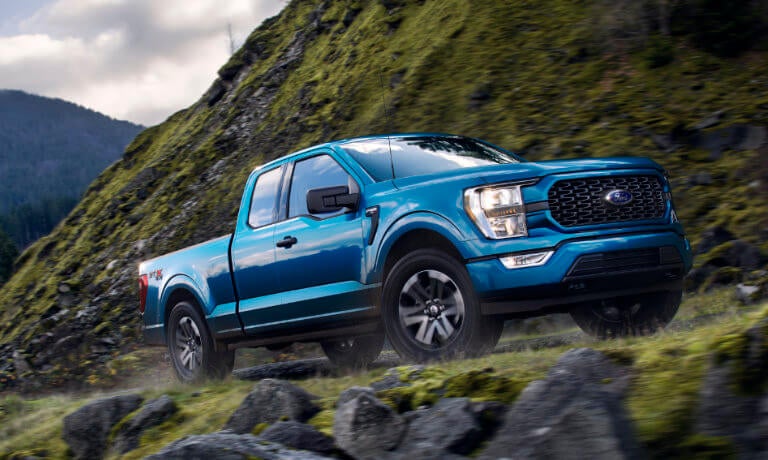 2022 Ford F-150 exterior driving on grassy mountainside